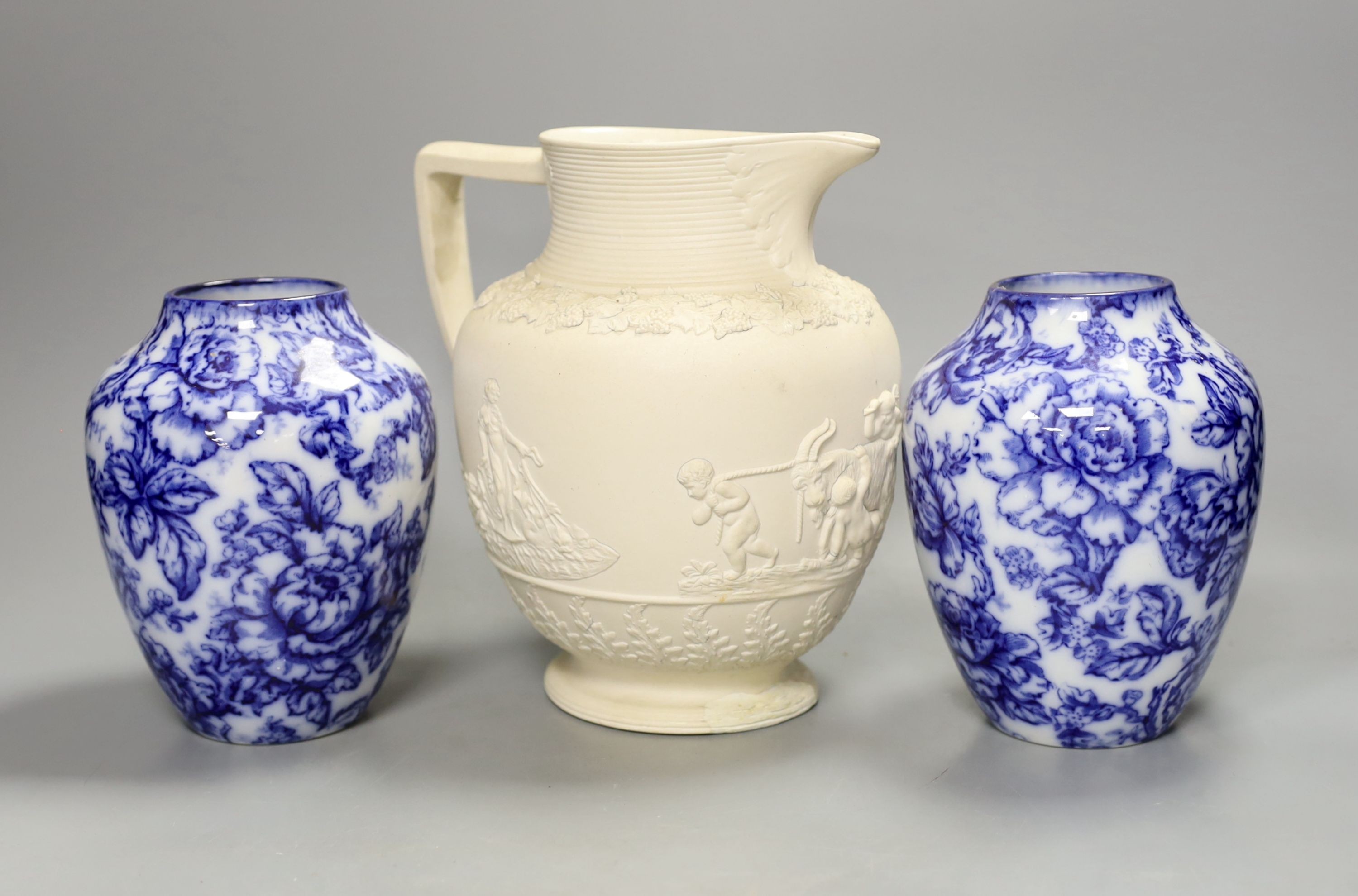 A pair of Keelings blue and white floral vases and a 19th century relief moulded white stoneware jug, vases 17 cms high.